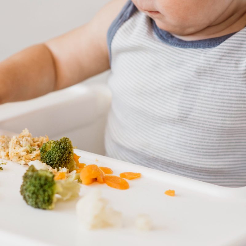 cute-baby-boy-highchair-choosing-what-eat